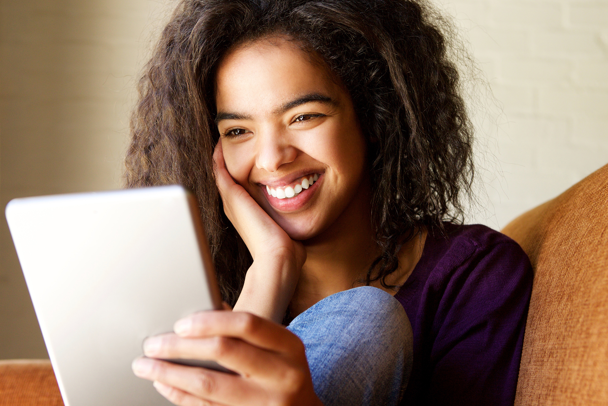 woman smiles as she looks at her RootsFinder free family tree sync with FamilySearch