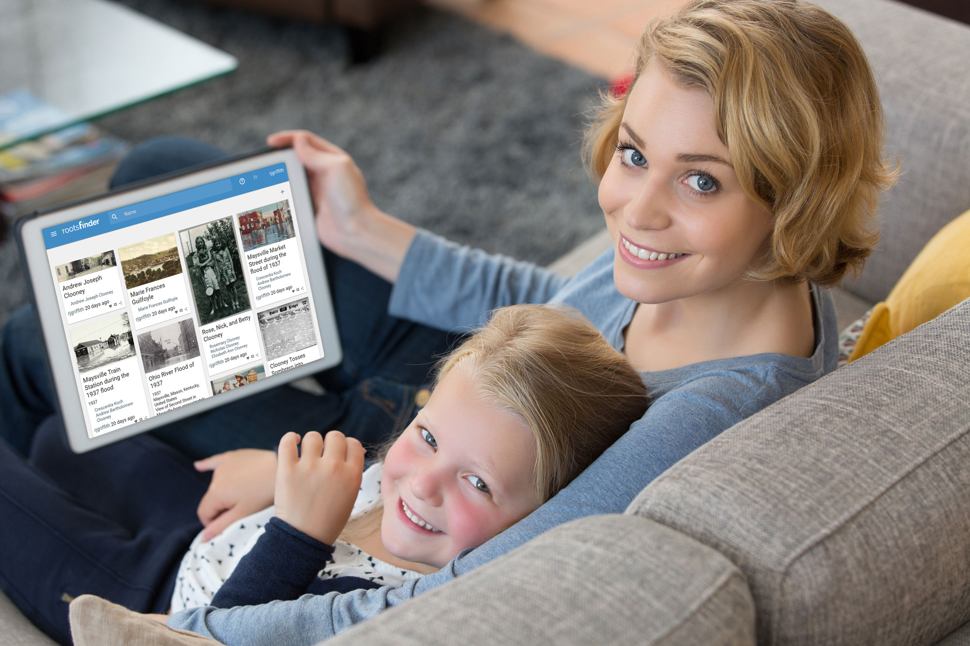 mother showing her daughter family history photos in RootsFinder's free family tree